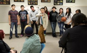 GWYNETH ROBERTS/Lincoln Journal Star1491s member Bobby Wilson (center) dances for the camera as Native Youth Leadership Symposium Participants (rear) watch during production of a public service announcement video Tuesday, April 2, 2013, at Morrill Hall.