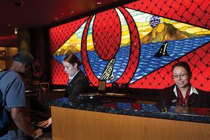 BUSINESS JOURNAL PHOTO | Karen DThe reception desk at the Tulalip Resort and Casino, with Shaelei Lucas (left) and Laureen Guzman. Twenty percent of the resort’s business – excluding the casino – comes out of Canada, but most of the casino business comes from Marysville, Everett and Seattle, areas that still have access to the Tulalip, albeit a route that could be clogged with traffic now.