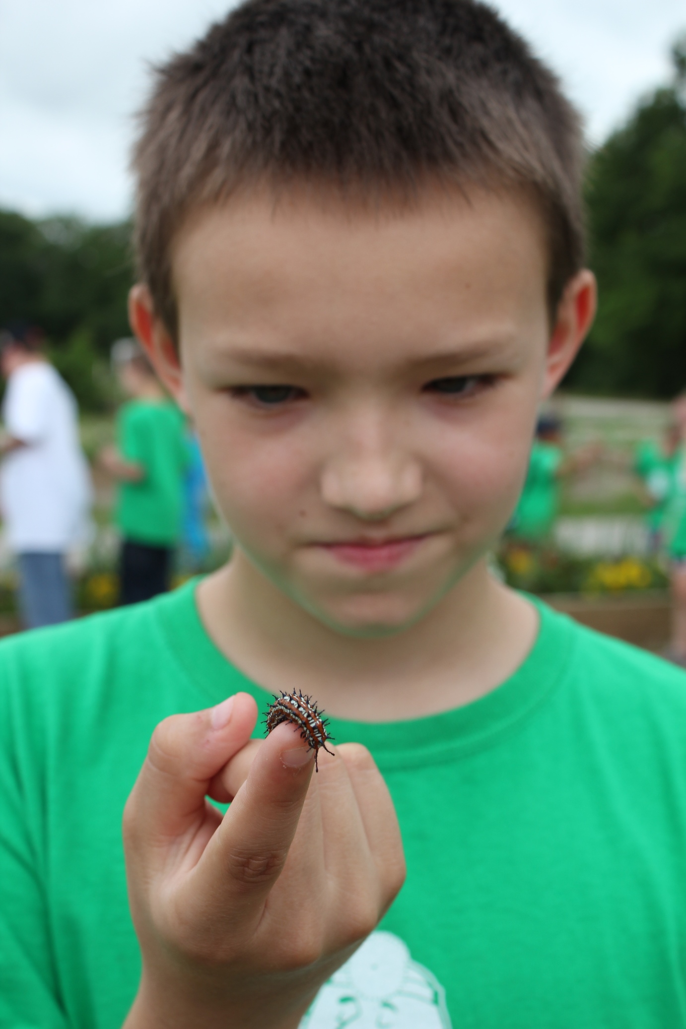 Ten-year-old Sean Higdon, Ada, checks out a caterpillar at the Chickasaw Nation Community Gardens during Environmental Camp. 