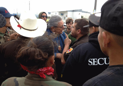Oglala Sioux president Brian Brewer being harassed before arrest. Photo: Intercontinental Cry