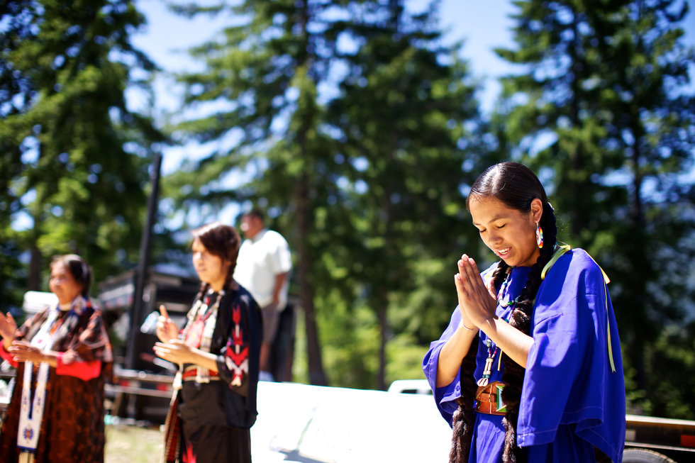 LAKE CLE ELUM, WASHINGTON - Jun. 13, 2013 - Tribal dancers Vivian Delarosa, Nia Peters and Katrina Blackwolf, left to right, sign the Lord's prayer before the meal after sockeye salmon were released into the lake, Wednesday, July 10, 2013, to mark the first return of sockeye salmon to Lake Cle Elum in 100 years. Sockeye salmon were reintroduced to the lake in 2009 by the Yakama Nation and the fish released today are the first of those salmon to return to the lake. Thomas Boyd/The Oregonian 