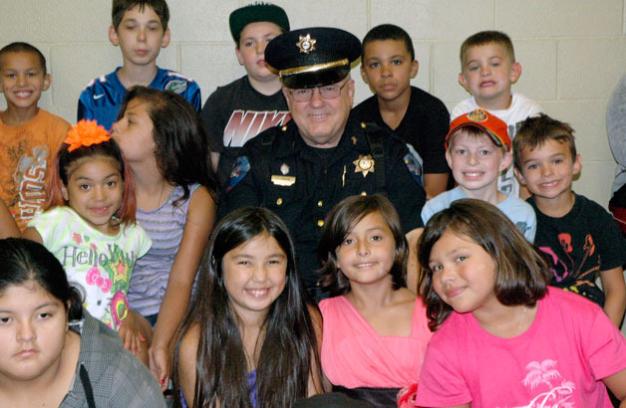 Kirk BoxleitnerTulalip Tribal Police Officer Larry Groom meets with the kids of the Tulalip Boys & Girls Club one last time, one day before stepping down from the force on July 26.