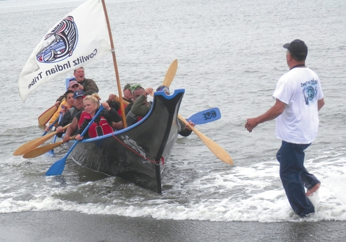 Angelo Bruscas/North Coast News Members of the Cowlitz Indian Tribe land their canoe at Damon Point in Ocean Shores July 29.