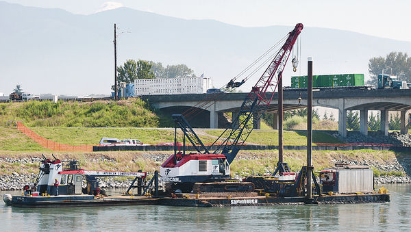 A work barge stationed downstream next to the I-5 Skagit River bridge was positioned there Tuesday morning. Work will begin this summer on the permanent replacement span. Scott Terrell / Skagit Valley Herald