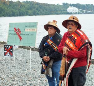 Lummi Nation then-Chair Cliff Cultee (left) and Hereditary Chair Bill James with the check they will burn at Cherry Point. Photo: Floyd McKay 
