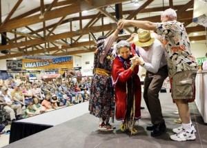 Roberta Conner of Tamastslikt Cultural Institute benefits from audience participation as women from the Confederated Tribes of the Umatilla showcase traditional dances on the last day of the Oregon State Fair. / Thomas Patterson / Statesman Jou