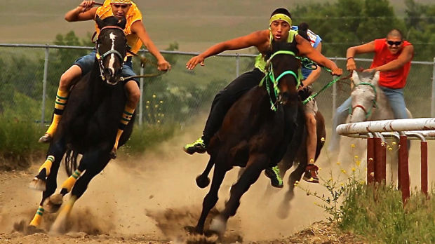 From left, Zack Rock and Luke Rock head into the home stretch during a relay race at the Crow Native Days in Crow Agency. MontanaPBS will feature the native sport in the documentary ‘Indian Relay.’