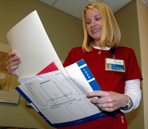 Janel Jacobson, a medical assistant at the Providence Comprehensive Breast Center in Everett, reviews a patient’s charts.— image credit: File Photo