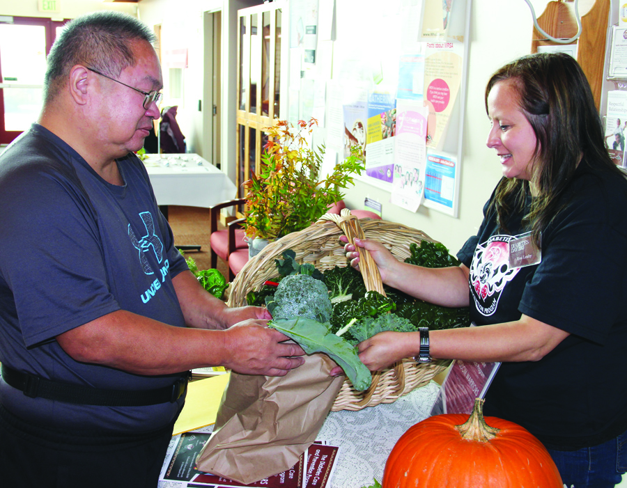 Tribal member Ron Anchetta takes home the broccoli he grew in the community garden at the health clinic. 