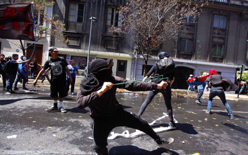 Some of the protesters threw rocks and other objects at police after the main, peaceful march earlier Saturday. Photo: Luis Hidalgo/AP