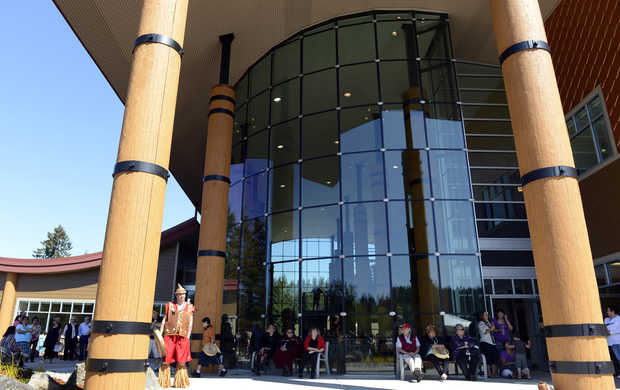 People gather in front of the new, 26,000-square-foot Nisqually Tribal Center, during a dedication ceremony, Friday May 3, 2013, in Olympia. The building, which was built opposite the tribe's previous center, will house most of the governmental services provided to tribal members. Tribal history, tradition and culture are incorporated into the building's design.(Janet Jensen/Staff photographer)JANET JENSEN — Staff photographer 