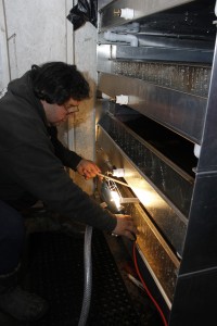 Little Boston Hatchery technician Jeff Fulton works with a tray of eggs in the new NOPAD incubator system. More photos can be found by clicking on this photo.