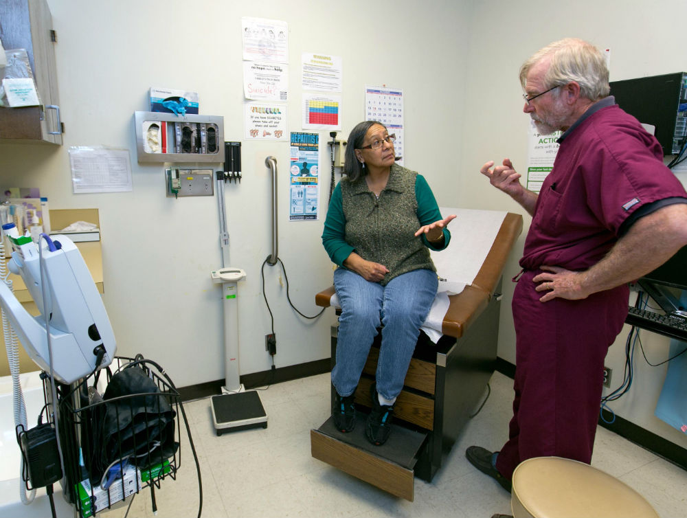 Norma Thomas, a resident of Owyhee on the Duck Valley Indian Reservation, talks with David Simons, a doctor at the Shoshone-Paiute Tribes Owyhee Community Health Facility in Nevada on Nov. 25, 2013. (Darin Oswald for The Washington Post)