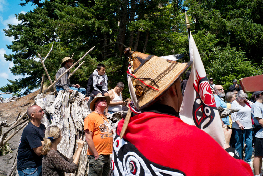 Damian MulinixA crowd of tribal members and spectators take to the beach below Fort Columbia to honor the arrival of a canoe that carries the first salmon during Friday’s ceremony.