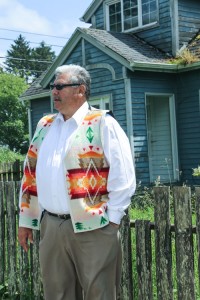 Larry Ralston, Quinault Indian Nation Treasurer, stands in front of his mother's house which will not be moved during the relocation of Taholah's Lower Village, and could face possible demolition along with other buildings that cannot be moved. Photo/ Brandi N. Montreuil, Tulalip News