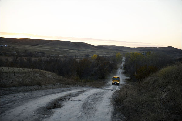In this Oct. 24, 2013, photo a school bus heads up Tobacco Road on the Pine Ridge Indian Reservation in South Dakota.—Swikar Patel/Education Week