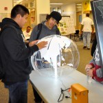 Students observe exhibits setup for GIS day at Heritage High School