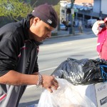 Chief Seattle Club volunteer Robert Brown helps to haul in the donation of clothing and blankets from Tulalip. 