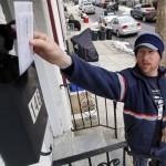 In this Tuesday, March 2, 2010 photo, letter carrier Kevin Pownall delivers mail in Philadelphia. Photo: MATT ROURKE / AP