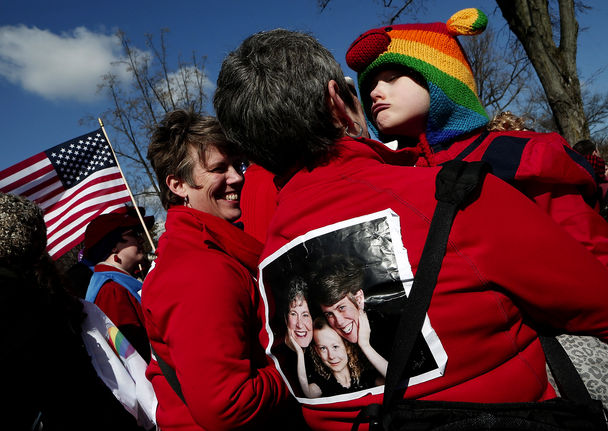 From left, the Rev. Rebecca Voelkel, partner Maggie George and their daughter Shannon Voelkel take part in a demonstration in front of the U.S. Supreme Court on Tuesday as justices heard arguments on the California Proposition 8 appeal. Win McNamee / Getty Images