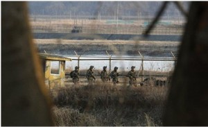 South Korean army soldiers patrol along a barbed-wire fence near the border village of Panmunjom in Paju, South Korea, Wednesday, March 27, 2013. North Korea said Wednesday that it had cut off a key military hotline with South Korea that allows cross border travel to a jointly run industrial complex in the North, a move that ratchets up already high tension and possibly jeopardizes the last major symbol of inter-Korean cooperation.Ahn Young-joon — AP Photo