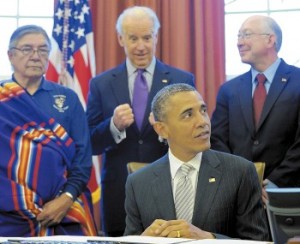 Vice President Joe Biden, center, reacts after President Barack Obama signs legislation under the Antiquities Act designating five new national monuments on Monday in the Oval Office. From left are Samuel Gomez, war chief for Taos Pueblo, Biden, and Interior Secretary Ken Salazar. (susan walsh/the associated press)