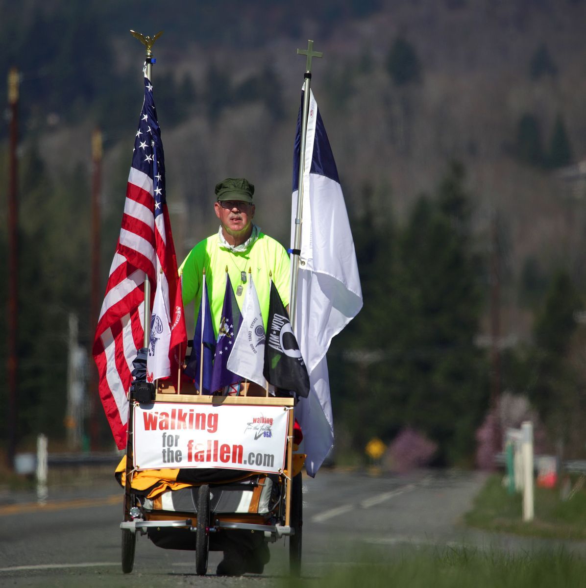 Mark Mulligan / The HeraldChuck Lewis, a Marine Corps veteran living in Ronan, Mont., walks eastbound down U.S. 2morning toward Gold Bar on Monday, the second day of a 3,300 mile, 6-month journey across the U.S.