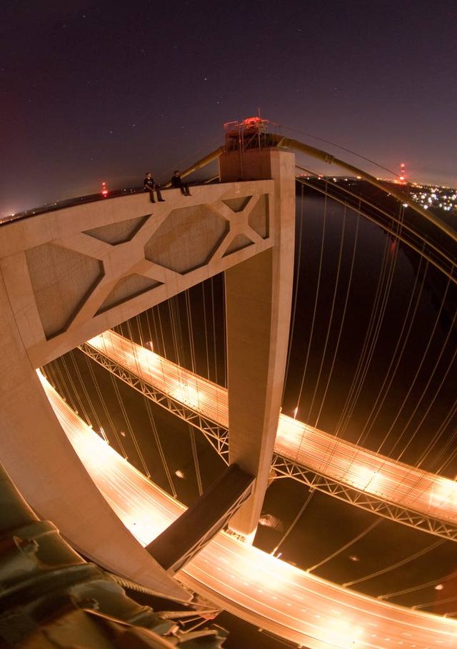 Daredevils sit atop the Tacoma Narrows Bridge in this undated photo posted on RedditPhoto by Reddit/Shuttersubversive