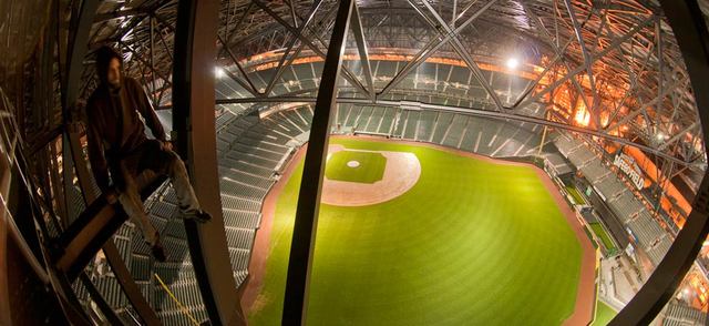 An unidentified climber poses in the rafters of Safeco Field's retractable roof. (Photo via Reddit/Shuttersubversive) 