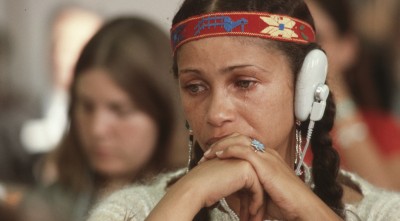 •ÄúAn unidentified woman listening to translated testimony on the sterilization of Indian women.‚Äù This pix of a lovely young woman crying was taken apparently at a United Nations International NGO Conference on Indigenous Peoples and the Land in Geneva, Switzerland, Sept. 15 ‚Äì 18, 1981. provided by Minnesota Historical Society Press. Photos by Dick Bancroft