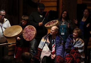 Nick Adams / The HeraldMarysville School District Superintendent Larry Nyland and Assistant Superintendent Gail Miller listen to songs by the Tulalip Tribes during a retirement party at the Hibulb Cultural Center on May 30. Both school officials are retiring.