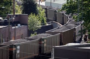 Jennifer Buchanan / The HeraldA coal train passes through Everett in May. Proposed export terminals would increase the number of trains between Seattle and Bellingham.