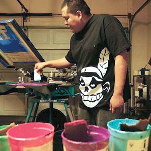 (Courtesy photo)Jared Yazzie hand paints a T-shirt in his studio as he prepares for a fashion show. 