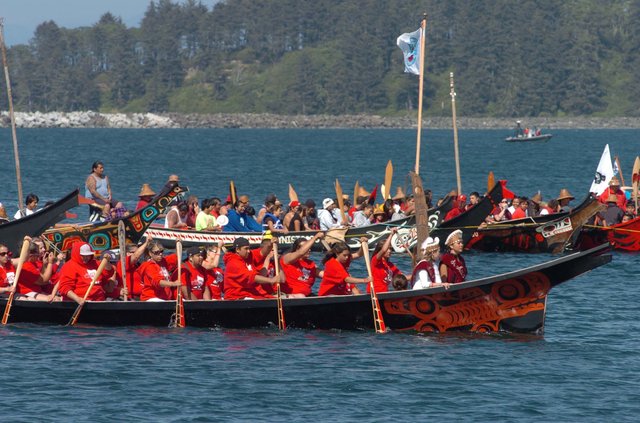 Chris Tucker/Peninsula Daily News filesPullers from the Port Gamble S’Klallam tribe, front, paddle their canoe toward a ceremonial landing Monday in Neah Bay. Eighty-six canoes from across the Pacific Northwest joined in the 2010 Tribal Canoe Journey. Nine people were rescued Monday off Port Townsend after their canoe overturned in Salish Sea waters during the annual journey.