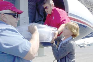 (Times photo – Shondiin Silversmith)U.S. Army Corps of Engineer workers Julia Price, right, and Ron Kneebone, left, unload artifacts that were recovered from South Dakota. 