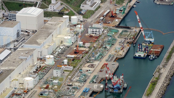 This aerial photo taken on July 9, 2013 shows reactor buildings Unit 2, left, and Unit 1 at Fukushima Dai-ichi nuclear power plant in Okuama, Fukushima Prefecture, northern Japan. Japan’s nuclear regulator says radioactive water from the crippled Fukushima power plant is probably leaking into the Pacific Ocean, a problem long suspected by experts but denied by the plant’s operator. (AP/Kyodo News) 