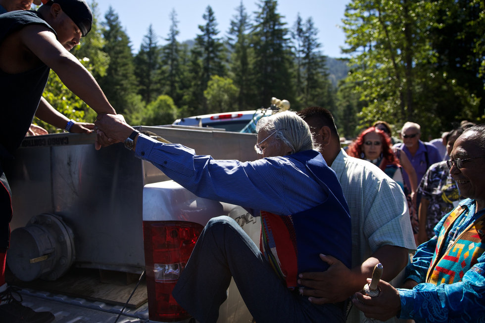 LAKE CLE ELUM, WASHINGTON - Jun. 13, 2013 - Tribal elder Russell Jim is helped in to the bed of the truck to release sockeye salmon into the lake, Wednesday, July 10, 2013, to mark the first return of sockeye salmon to Lake Cle Elum in 100 years. Sockeye salmon were reintroduced to the lake in 2009 by the Yakama Nation and the fish released today are the first of those salmon to return to the lake. Thomas Boyd/The Oregonian 