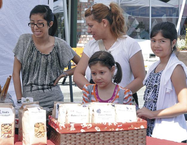 File PhotoFrom left, Alondra, Maria, Suzie and Khiara Morgan browsed over a table of gourmet dog treats during last year’s Homegrown Festival, which this year has been rechristened the Marysville Street Festival: Handmade & Homegrown.