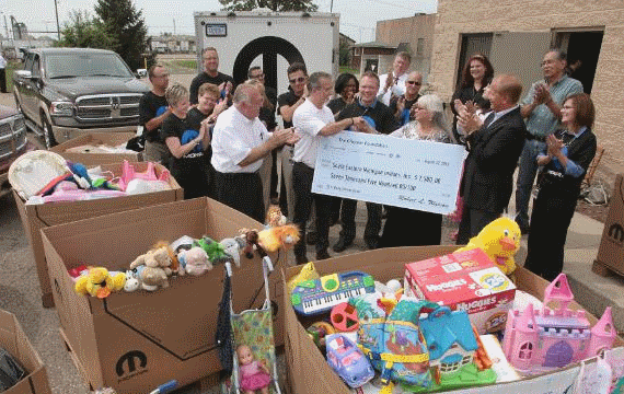 Pietro Gorlier, CEO and President Mopar, delivered hundreds of baby supplies and a cash donation to Sue Franklin of Southeastern Michigan Indians Inc. that were collected and then unloaded by employees from Chrysler's Mopar.