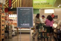 Mark Mulligan / The HeraldWhole Foods is encouraging shoppers to "Say Yes on 522" with signs and other literature distributed around its stores, including at their Lynnwood location Thursday morning.