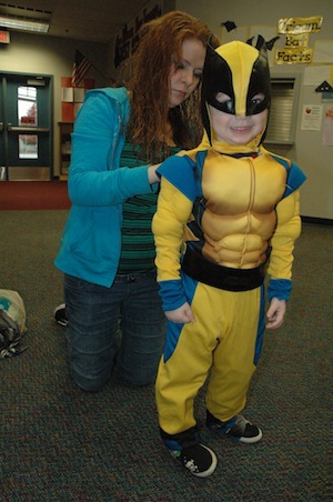 Karen Whitehead helps her son Bryson don his Wolverine costume at the Oct. 22 'Give a Costume, Take a Costume' exchange in preparation for the Oct. 26 HiJinx Carnival.— image credit: Kirk Boxleitner