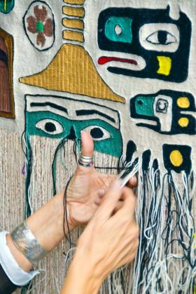 Photo by Peter MetcalfeChloe French weaves her first Chilkat robe during a weavers' demonstration at the Sharing Our Knowledge Conference at Centennial Hall in 2009.