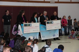Members of the NEA and WEA present banners and library checks at Tulalip Quil Ceda Elementary.