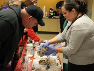 Bonnie and Bryce Juneau looking at a heart with a Gortex valve. Valve damage was due to heroin use.Photo: Andrew Gobin, Tulalip News