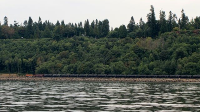 An oil train moves along Puget Sound, headed to refineries in the Northwestern part of the state. | credit: Ashley Ahearn 