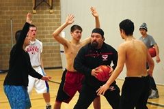Genna Martin / The HeraldA group of Tulalip Heritage players guard assistant coach Cyrus Fryberg Jr. (center) during a drill at a recent practice. The Hawks are motivated to get to the state tournament in Spokane after falling just one game short last year.