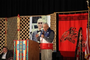Nisqually elder Billy Frank Jr., a lifelong fisherman who led the battle for Treaty Indian fishing, speaks to an audience of tribal leaders past and present, activists, but most of all friends, remembering the Boldt Decision with stories. Photos of “The Old Swede,” as Billy called Judge Boldt, hung as a backdrop in memory of his momentous decision.