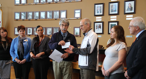 Tulalip Tribes Chairman Mel Sheldon presents a donation check in the amount of $100,000 to Chuck Morrison, regional executive director of the Snohomish County chapter of the American Red Cross. The donation will help assist with shelter, food and basic needs for the survivors and families devastated by the Oso, WA mudslide.Photo/ Brandi N. Montreuil, Tulalip News 