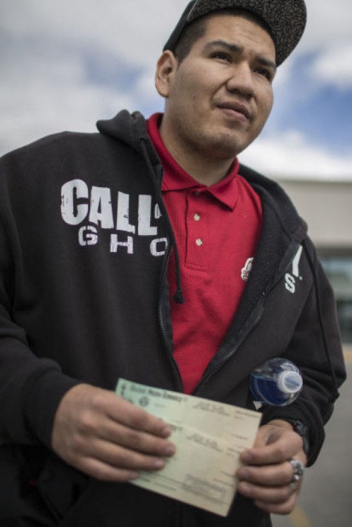 James C'Hair shows settlement checks from the Office of the Special Trustee for American Indians received by him and his wife Wednesday outside Atlantic City Federal Credit Union in Riverton.Ryan Dorgan | Star-Tribune