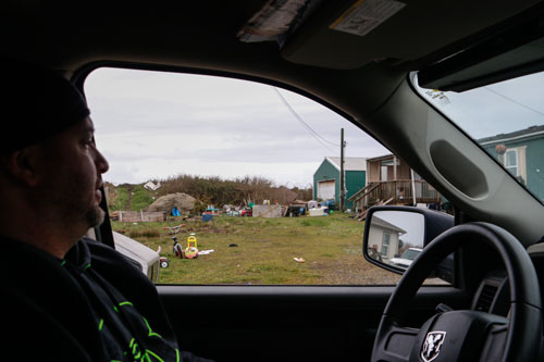 Quinault Emergency Management staff member John Preston, drives past a residence that sustained damage due to the breach on Tuesday evening, March 25.Photo/ Brandi N. Montreuil, Tulalip News